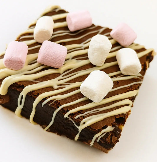 triple chocolate brownie topped with marshmallows and white chocolate